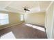 Large main bedroom featuring carpet flooring, tray ceiling, and bright natural light at 2378 Misty Ivy Ct, Buford, GA 30519