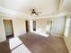 Spacious main bedroom with carpet flooring, tray ceilings, and multiple entryways at 2378 Misty Ivy Ct, Buford, GA 30519