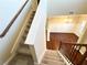Carpeted staircase leads to a living area with hardwood floors and elegant chandelier at 2378 Misty Ivy Ct, Buford, GA 30519
