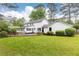 Backyard of house with a lawn, tall trees and a wood deck at 2730 Burtz Dr, Marietta, GA 30068