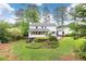 Lush backyard featuring well-manicured lawn and patio adjacent to the back of a white home at 2730 Burtz Dr, Marietta, GA 30068