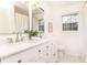Bright bathroom featuring a dual sink vanity with white cabinets and a large mirror at 2730 Burtz Dr, Marietta, GA 30068