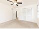 A bright bedroom features neutral carpet, a ceiling fan, and closet space at 2730 Burtz Dr, Marietta, GA 30068