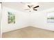 A carpeted bedroom includes windows, a ceiling fan, and neutral walls at 2730 Burtz Dr, Marietta, GA 30068