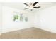 A bright bedroom features neutral carpet, a ceiling fan, and a window that brings in natural light at 2730 Burtz Dr, Marietta, GA 30068