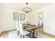 Formal dining room with modern chandelier, paintings, and seating for four at 2730 Burtz Dr, Marietta, GA 30068