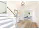 Bright entryway with wood floors, staircase, and a glimpse into the living room with natural light at 2730 Burtz Dr, Marietta, GA 30068