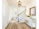 Bright entryway featuring wood floors, white walls, staircase, and a decorative console table at 2730 Burtz Dr, Marietta, GA 30068