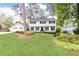 Charming white two-story home featuring lush landscaping, a well-maintained lawn, and a two-car garage at 2730 Burtz Dr, Marietta, GA 30068