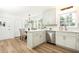 Updated kitchen featuring white cabinets, stainless steel appliances, and modern lighting at 2730 Burtz Dr, Marietta, GA 30068