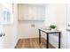 Functional laundry room with overhead cabinets, a table, and durable flooring at 2730 Burtz Dr, Marietta, GA 30068