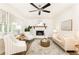 Bright living room with white brick fireplace, modern ceiling fan, and neutral furniture at 2730 Burtz Dr, Marietta, GA 30068