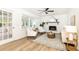 Bright living room features a white brick fireplace, light wood flooring, and sunroom access at 2730 Burtz Dr, Marietta, GA 30068