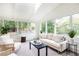 Bright sunroom with skylights, walls of windows, neutral decor, and comfortable seating at 2730 Burtz Dr, Marietta, GA 30068