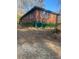 The back of this brick house has a flat grassy lawn and a stump at 3178 Beech Dr, Decatur, GA 30032
