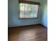Bright bedroom with hardwood flooring and view of outdoor greenery at 3178 Beech Dr, Decatur, GA 30032