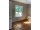 Bright bedroom with hardwood flooring, a window, and neutral walls at 3178 Beech Dr, Decatur, GA 30032