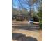 Cozy brick home with a carport and long driveway surrounded by mature trees at 3178 Beech Dr, Decatur, GA 30032