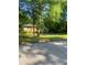 Cozy brick home with a covered carport surrounded by mature trees and a lush green lawn at 3178 Beech Dr, Decatur, GA 30032