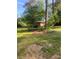 This house has a large front lawn surrounded by mature trees at 3178 Beech Dr, Decatur, GA 30032