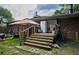 View of deck and backyard with brick house and mature trees, ready for summer gatherings at 8053 Duralee Ln, Douglasville, GA 30134