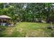 Huge backyard featuring mature trees, wooden deck, storage sheds and lots of potential at 8053 Duralee Ln, Douglasville, GA 30134