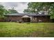 Expansive backyard with a brick house, wooden deck, and ample green space perfect for outdoor activities at 8053 Duralee Ln, Douglasville, GA 30134