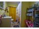 Cozy yellow bathroom featuring a sink, toilet, and a shower with patterned curtains and a storage rack at 8053 Duralee Ln, Douglasville, GA 30134