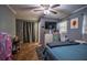 Gray bedroom with a bed, television, and sunflower painting at 8053 Duralee Ln, Douglasville, GA 30134