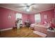 Pink themed bedroom featuring a bed, desk, and hardwood floors at 8053 Duralee Ln, Douglasville, GA 30134