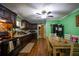 Spacious kitchen and dining area with dark wood cabinets, ample counter space, and a view into the living room, ideal for cooking and socializing at 8053 Duralee Ln, Douglasville, GA 30134