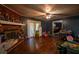 Cozy living room features hardwood floors, a brick fireplace, and access to the kitchen, creating a comfortable and functional living space at 8053 Duralee Ln, Douglasville, GA 30134