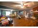 Spacious living room with hardwood floors, a cozy brick fireplace, and plenty of natural light, creating a warm and inviting atmosphere at 8053 Duralee Ln, Douglasville, GA 30134