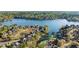 Stunning aerial view of lakefront homes with private docks surrounded by lush green trees and serene waters at 1125 Lake Shore Overlook, Alpharetta, GA 30005