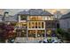 Exterior view of the home, highlighting a large covered patio with a stone lounge area at 1125 Lake Shore Overlook, Alpharetta, GA 30005
