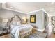 Stylish bedroom featuring a tufted headboard, designer lamps, and a cozy rug at 1125 Lake Shore Overlook, Alpharetta, GA 30005