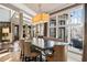 Dining room with large windows, neutral colors, stylish furniture, and modern chandelier at 1125 Lake Shore Overlook, Alpharetta, GA 30005
