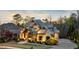 Beautiful exterior of a well-maintained two-story home with lush landscaping and stone accents at dusk at 1125 Lake Shore Overlook, Alpharetta, GA 30005