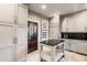 Well-lit kitchen boasts lots of cabinet space, an island with black countertop, and stainless appliances at 1125 Lake Shore Overlook, Alpharetta, GA 30005