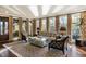Bright living room with neutral furniture, decorative curtains, and great natural light through the many windows at 1125 Lake Shore Overlook, Alpharetta, GA 30005