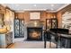Elegant living room features a fireplace, a baby grand piano, and custom built-in cabinets at 1125 Lake Shore Overlook, Alpharetta, GA 30005
