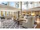 Open-concept living space with high ceilings, large windows, stylish furniture, and modern decor at 1125 Lake Shore Overlook, Alpharetta, GA 30005