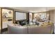 Inviting living room with curved sofa, entertainment center, and display shelves at 1125 Lake Shore Overlook, Alpharetta, GA 30005