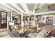 Spacious living room featuring hardwood floors, elegant furnishings, and an open floor plan to the kitchen at 1125 Lake Shore Overlook, Alpharetta, GA 30005