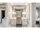 Elegant vanity area features a large mirror, custom cabinetry, and ample lighting at 1125 Lake Shore Overlook, Alpharetta, GA 30005