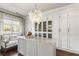 Custom walk-in closet with a marble island, custom lighting, and ample storage at 1125 Lake Shore Overlook, Alpharetta, GA 30005