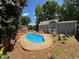 Backyard with in-ground swimming pool surrounded by mature trees at 1153 Staples Sw Dr, Lilburn, GA 30047
