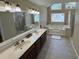 Bright bathroom with double vanity, soaking tub, and large mirror, providing a relaxing retreat at 1153 Staples Sw Dr, Lilburn, GA 30047