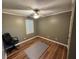 Bedroom with hardwood floors, ceiling fan, and a bright window at 1153 Staples Sw Dr, Lilburn, GA 30047