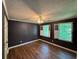 Bedroom featuring wood floors, modern fan, and bright windows at 1153 Staples Sw Dr, Lilburn, GA 30047